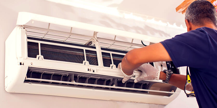 Technician fixing ductless unit 