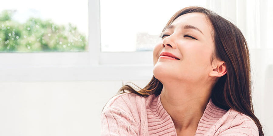 Woman breathing in clean air