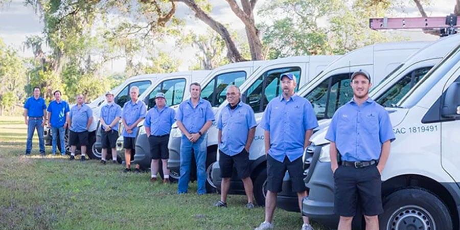 Rocket Cooling team standing in front of service trucks