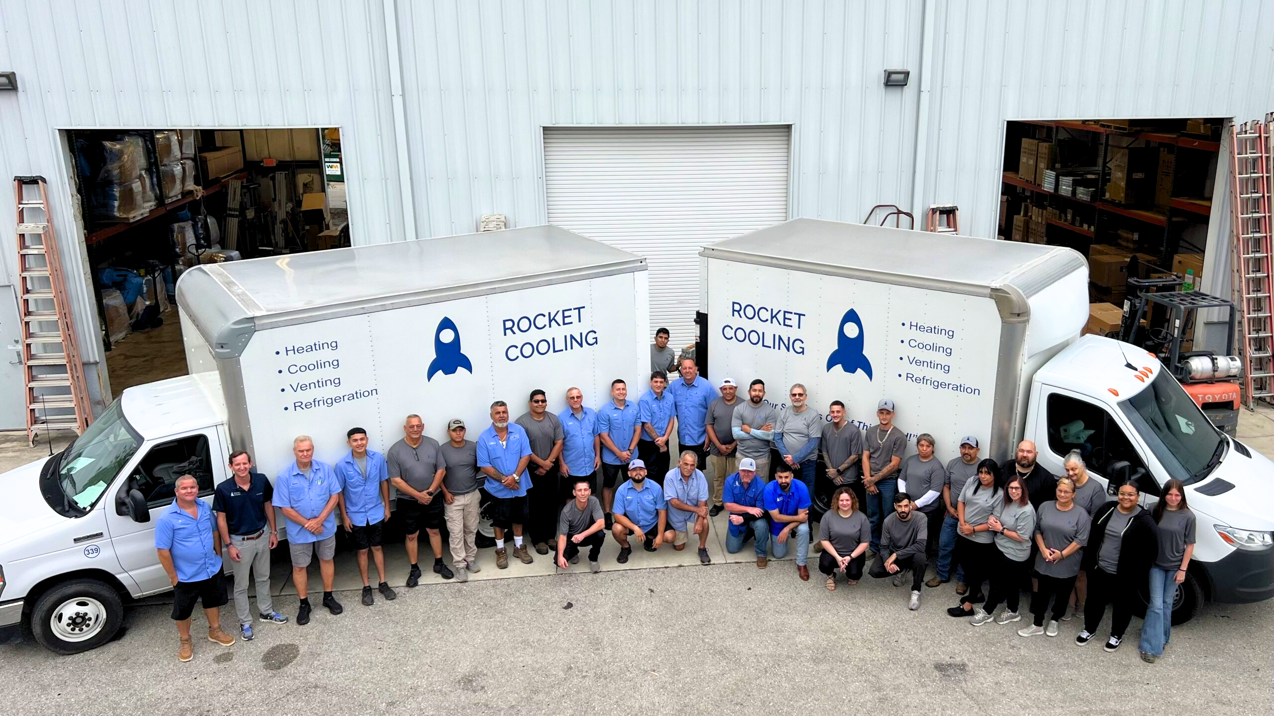 Rocket Cooling team standing in front of service trucks